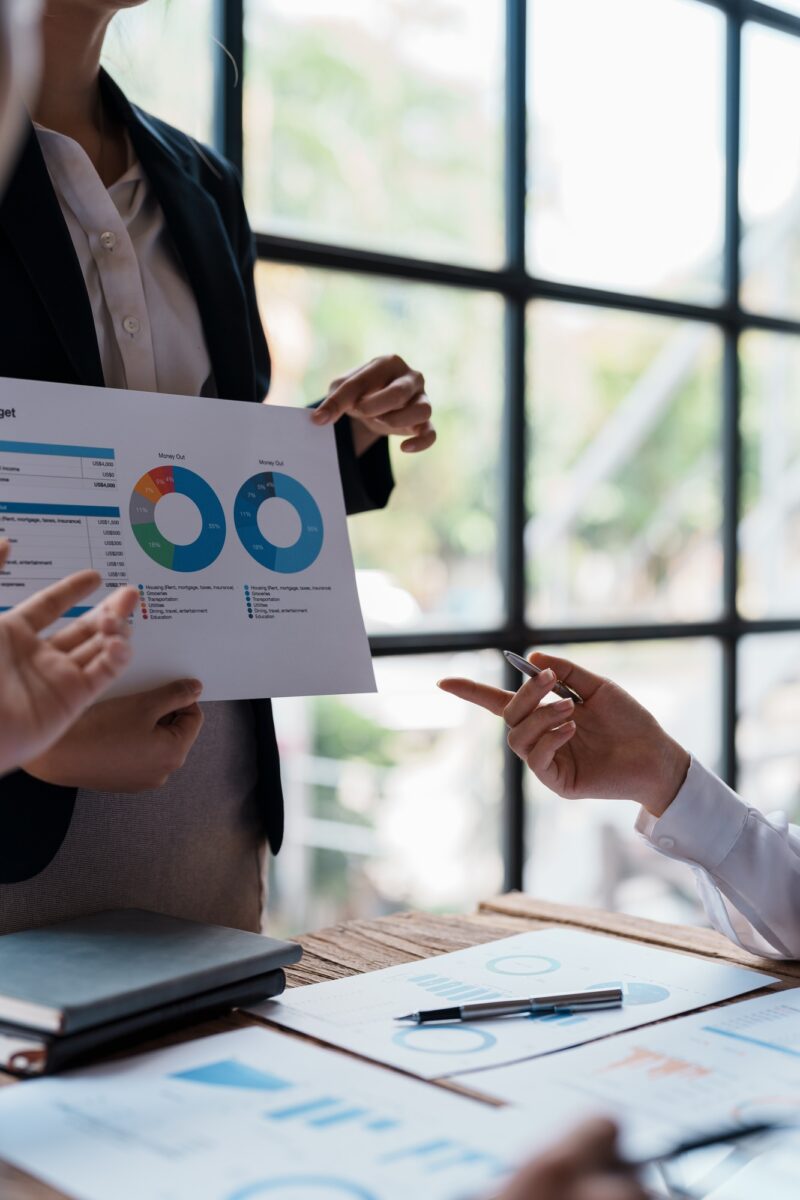 Business people meeting to plan, analyze and point to graphs and charts about business growth to pla